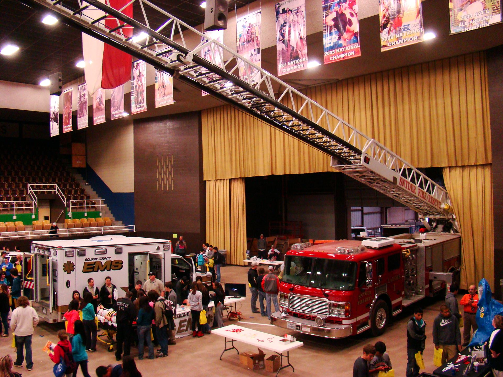 Fire truck with ladder extended in expo area.